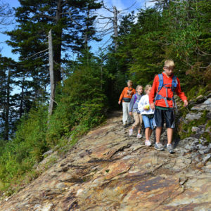 A family hikes in Acadia National Park